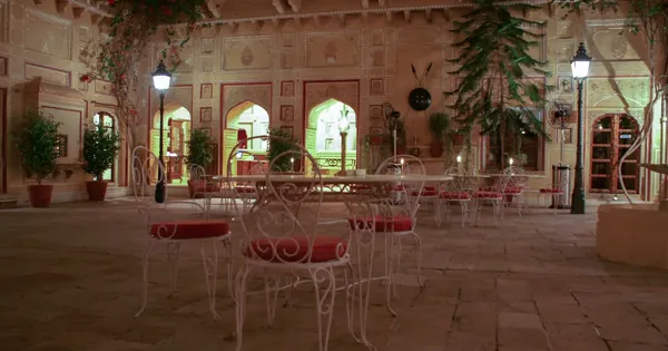 Illuminated inner courtyard at Samode Palace, Rajasthan, with heritage arches and outdoor dining tables